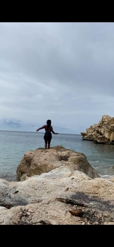 Stef Barti dancing outside in nature by the beach in Spain