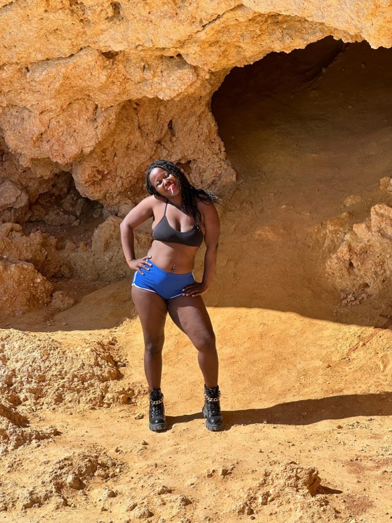 Stef Barti posing in front of cliff caves close to capoeiro Albufeira Portugal