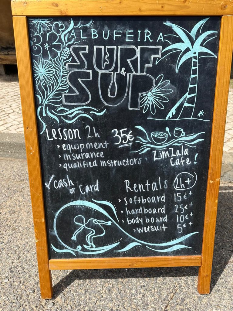 board showing surfing lesson prices at sup Albufeira surfing school