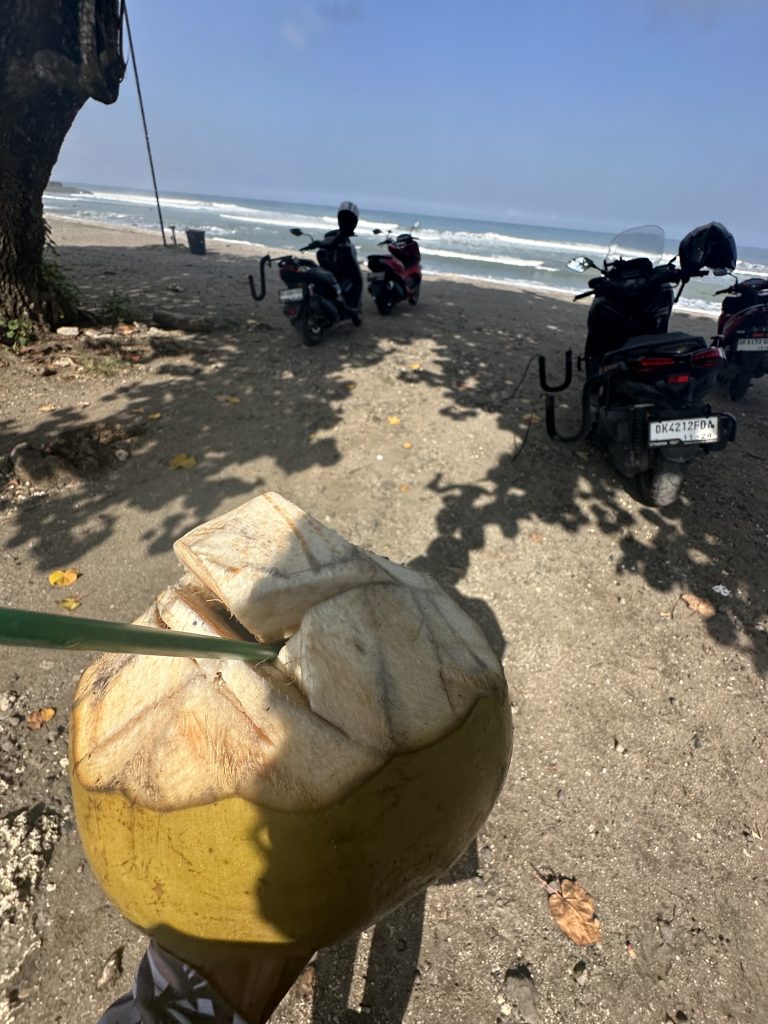 Stef Barti drinking Coconut water at the beach before surfing in Bali