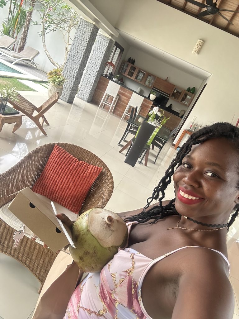 Stef barti signing into her rental in Canggu Bali, enjoying a welcome coconut drink