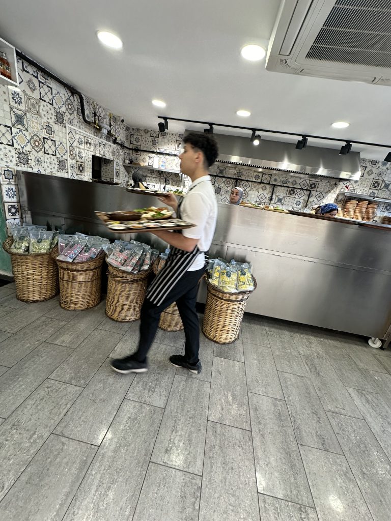 waiter carrying food at Mr Simone
