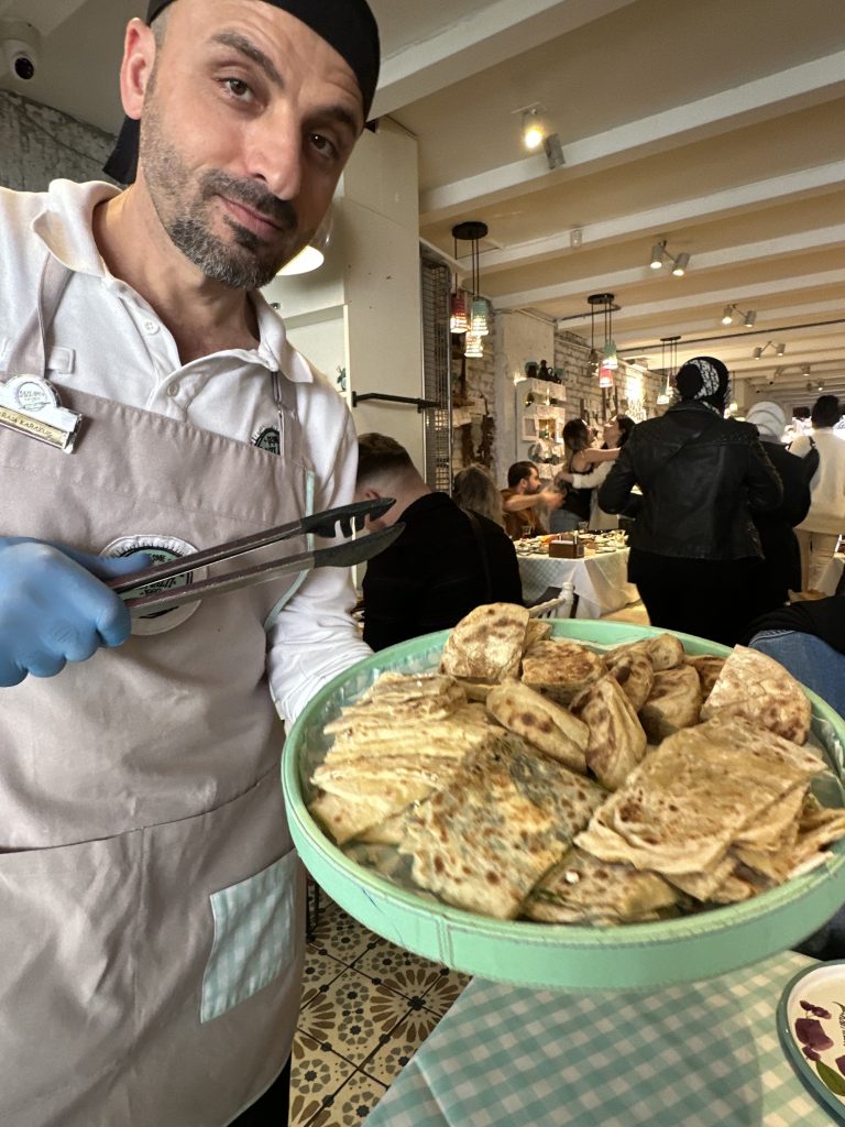 waiter offering bread to Stef Barti at Bazlama Istanbul