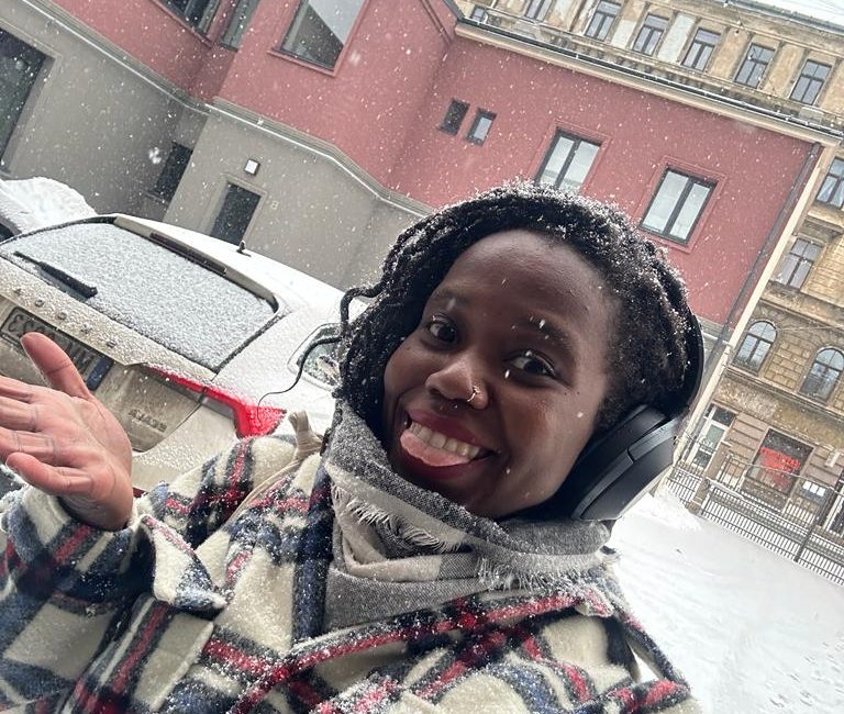 stef barti solo female travel in Riga Latvia takign a picture in the snow