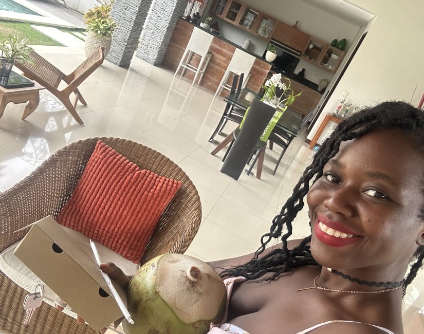 Stef barti signing into her rental in Canggu Bali, enjoying a welcome coconut drink