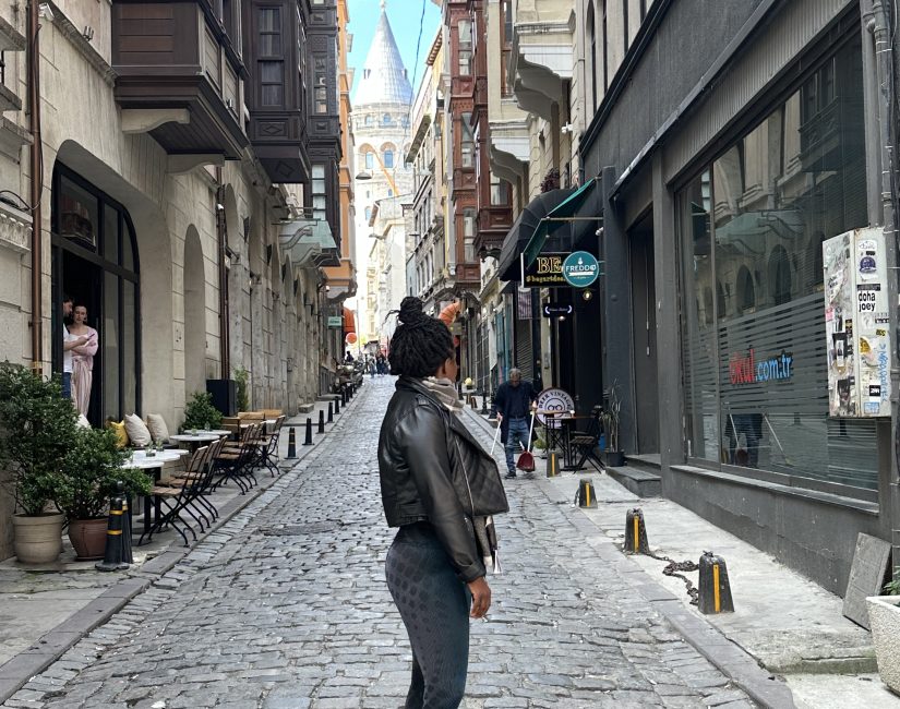 Stef barti posing in the streets of Istanbul in front of the Galata tower